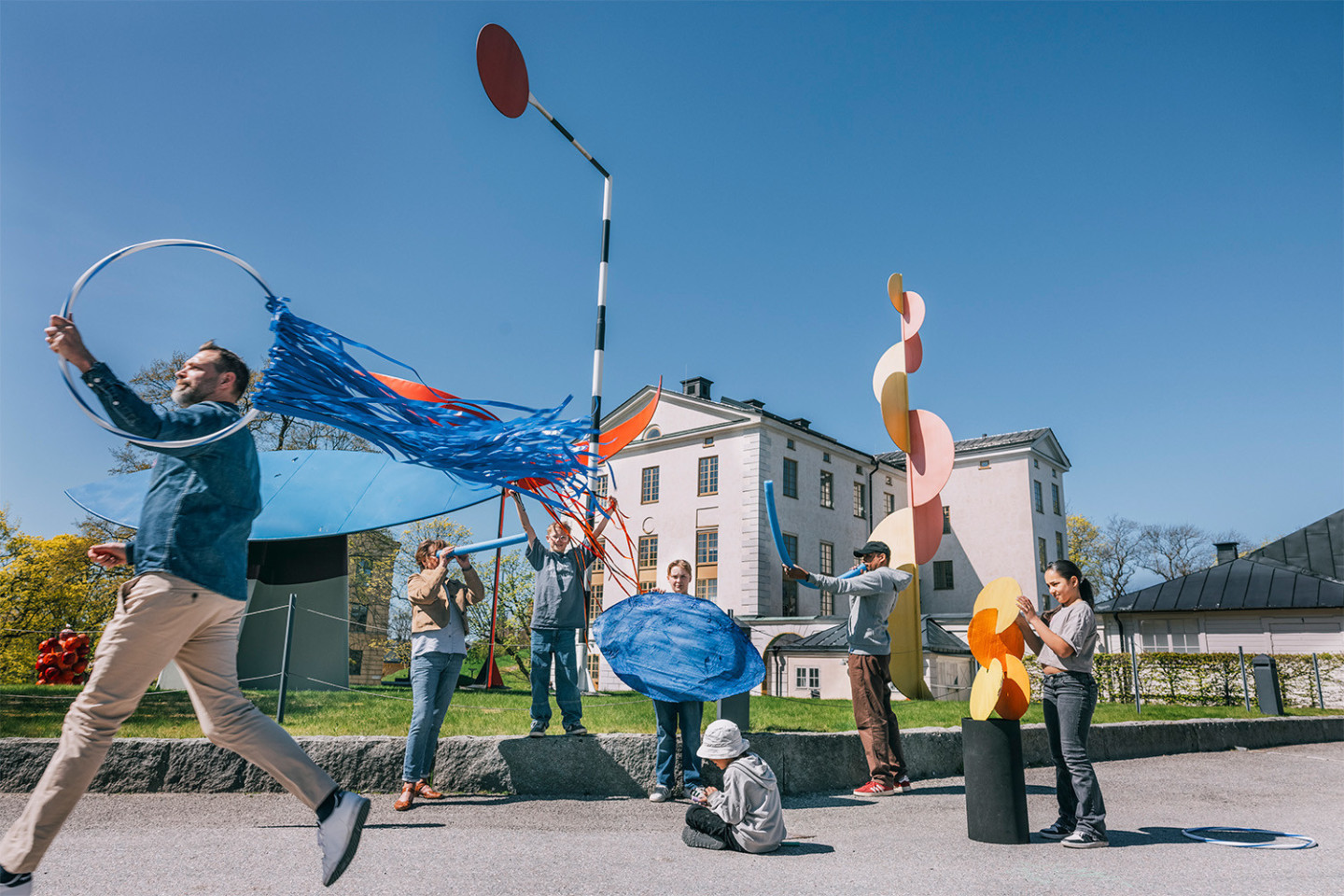 People play around the sculpture group "The Four Elements" by Alexander Calder, outside the Moderna Museet's entrance